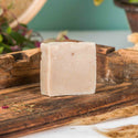 Bar of soap on a wooden surface with a natural background